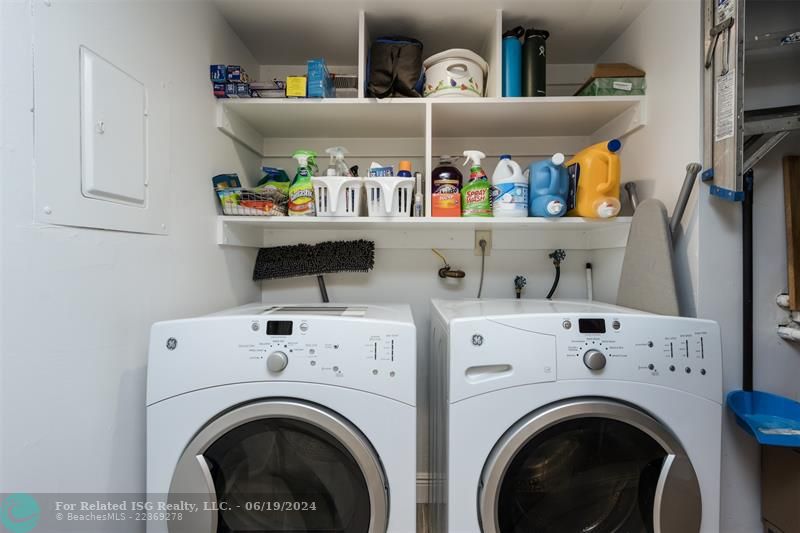 Laundry located in the kitchen, extra storage shelves, a tankless water heater, and the air conditioner. Front load Washer & Dryer.