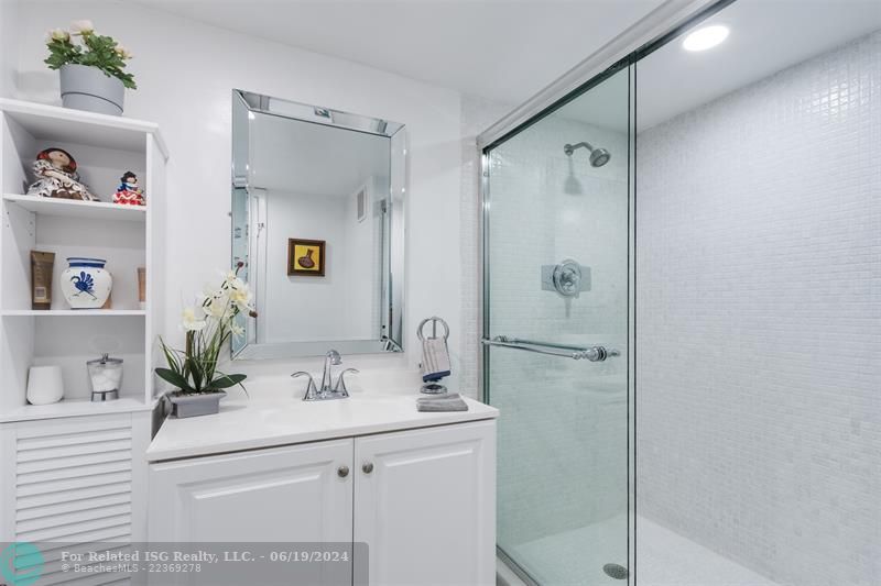 2nd full bathroom with walk in shower updated vanity and storage cabinet.