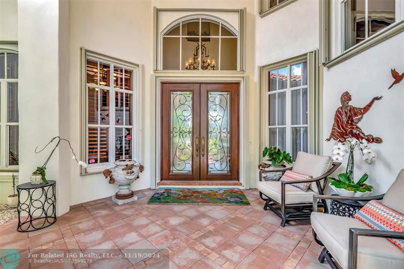 Stunning, Spacious Entrance with Grand Double Doors, Intricately Carved and Adorned with Elegant Hardware!