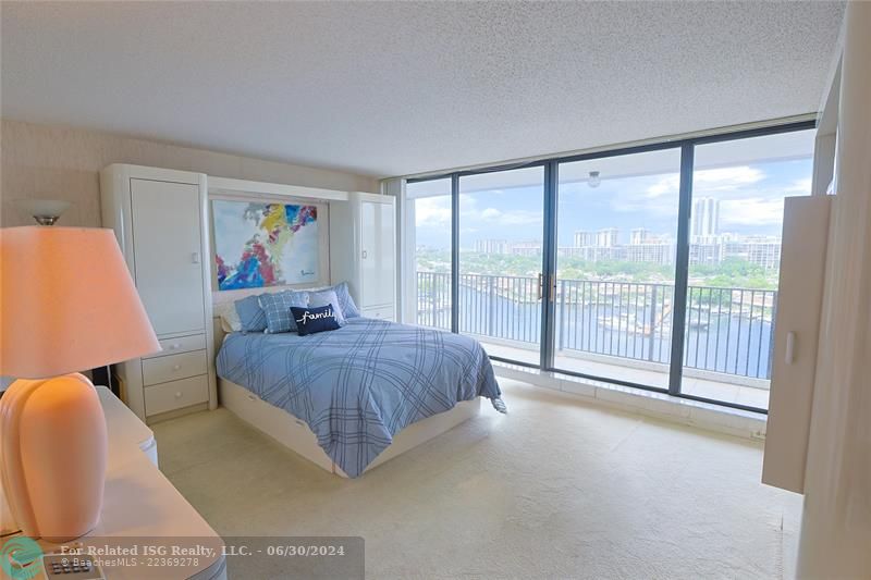 Open and bright master bedroom with floor to ceiling doors