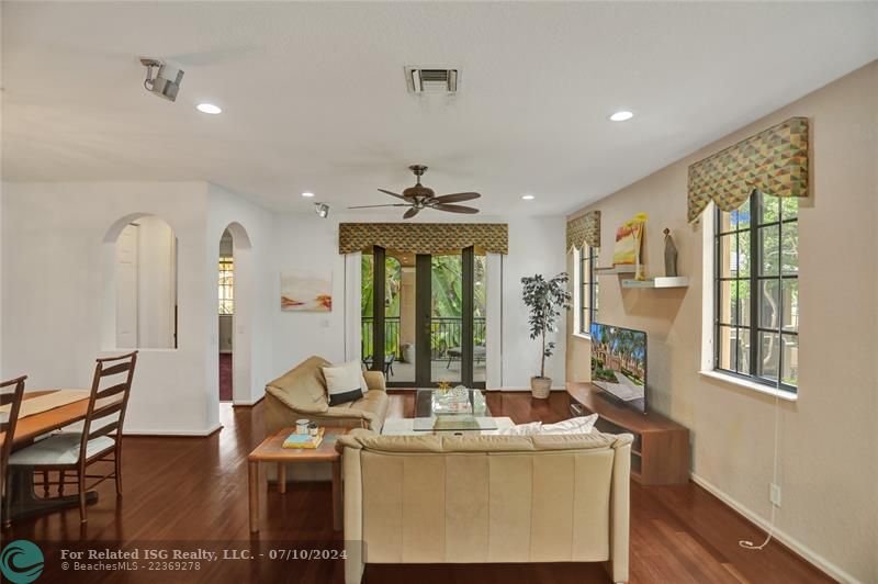 Impact glass and French doors lead to outdoor patio.