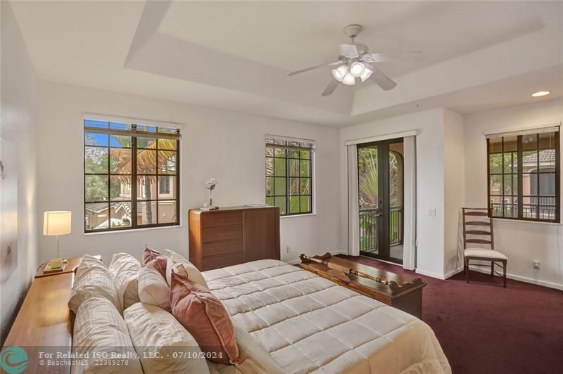 Spacious master suite with impact glass, French doors to patio.