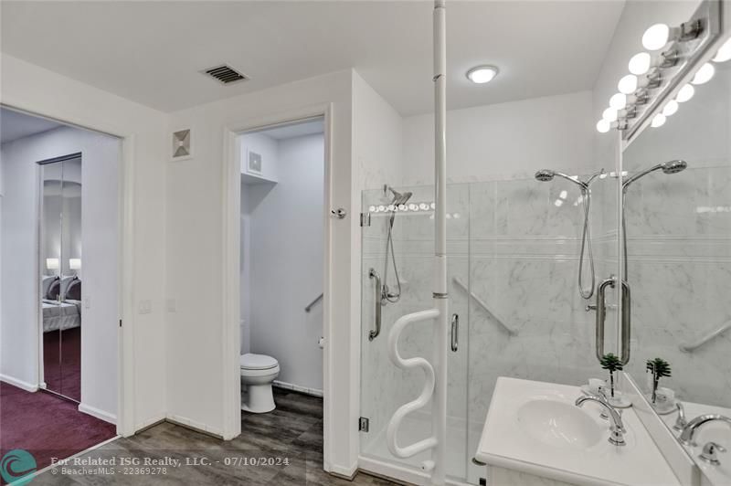 Renovated shower with seamless glass and grab bar for assistance (can be removed).