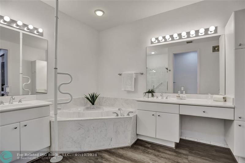 Marbled finishes to shower and tub, luxury vinyl flooring.