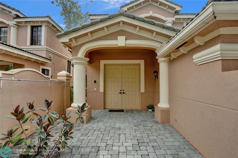 Brick paver courtyard with double door entry to your new home!