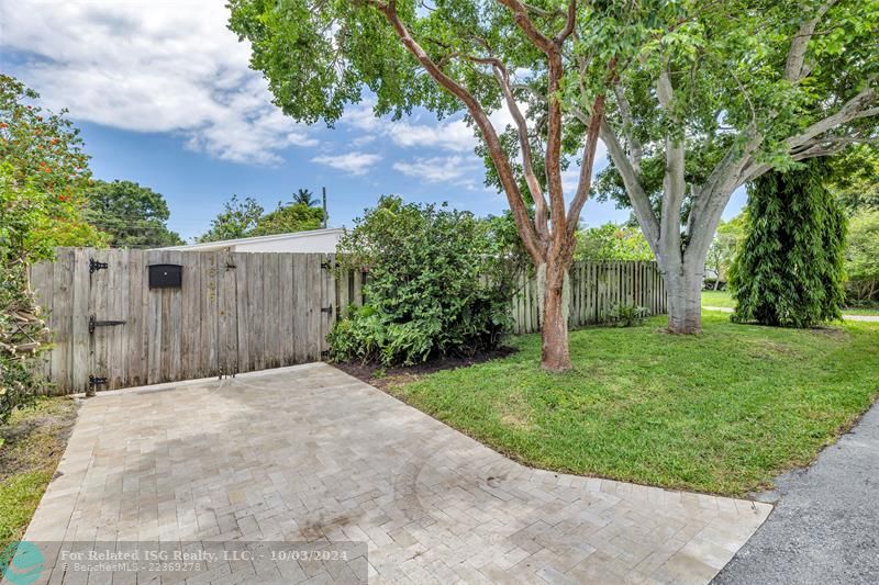 Private entrance and yard with gorgeous vegetation inside and outside of the fenced in yard