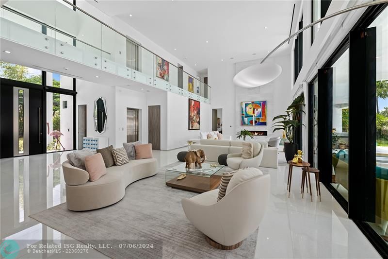 GRAND LIVING ROOM WITH SOARING CEILING AND NATURAL LIGHT