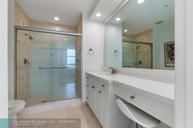 walk-in shower - white modern cabinetry and quartz countertops