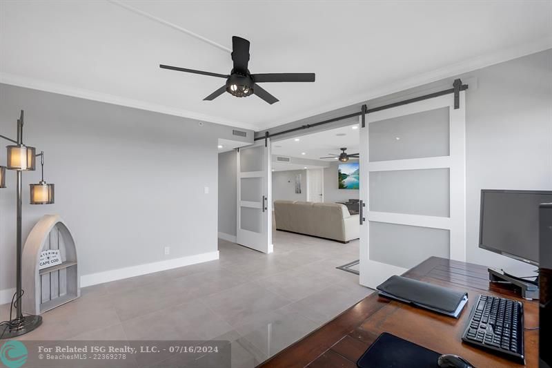 Double barn doors open from the guest room to the living room