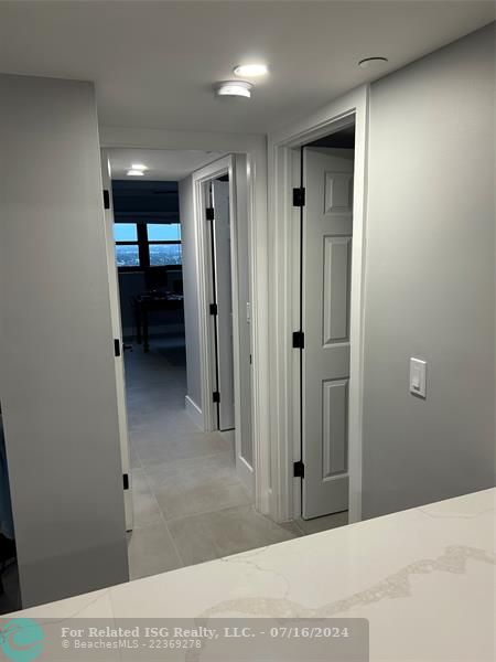 Hallway to the guest bathroom and guest bedroom and walk-in closet