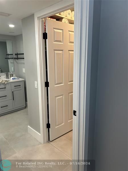 Primary bedroom walk-in closet and bathroom entry