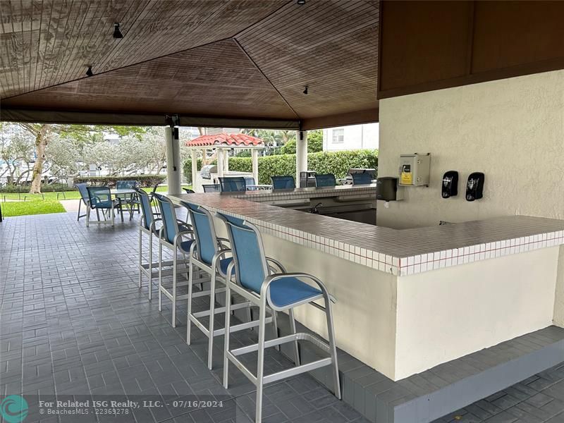 Covered, lighted BBQ Area and kitchen overlooking the marina