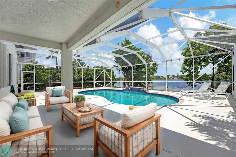 Expansive patio with covered area and brand-new LED light is screened-in for year-round outdoor comfort.