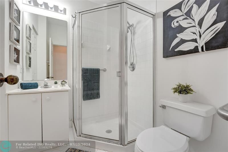 Full bathroom downstairs with shower, perfect for guests who prefer to be on first floor.