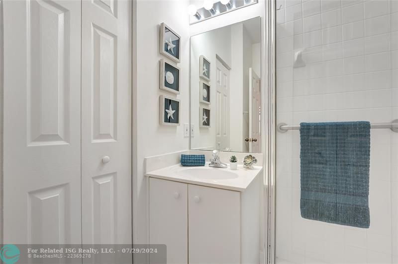 Full bathroom downstairs with shower and linen closet.