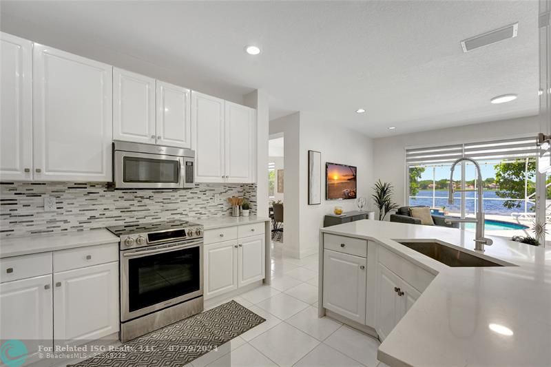 Newly remodeled kitchen opens to informal areas with amazing lake views!