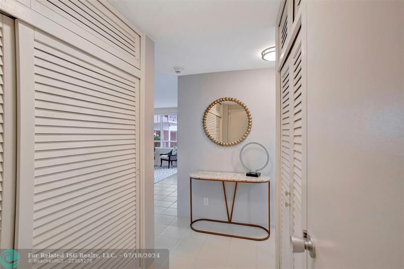 Foyer flanked with closets