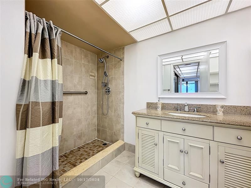 Tiled shower w newer fixtures and vanity