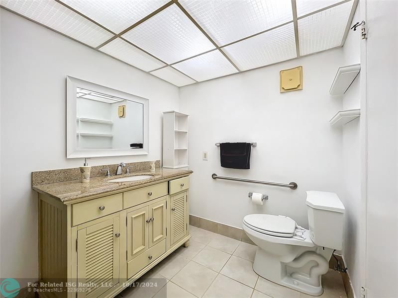 Tiled shower w newer fixtures and vanity