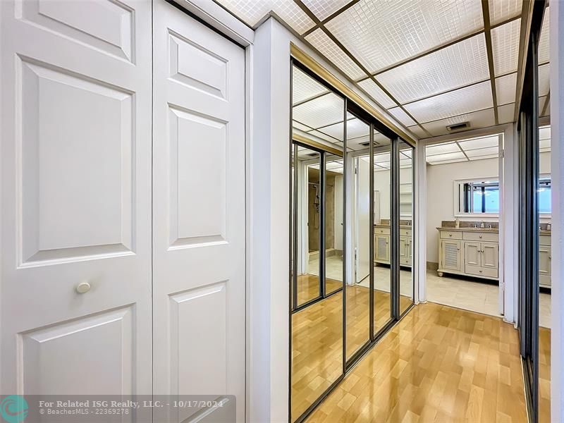 Closet area with sliding doors and linen closet