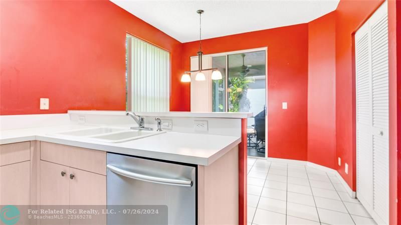 Full eat in kitchen or dining area with pantry, sliding glass doors leading out to screen roofed patio