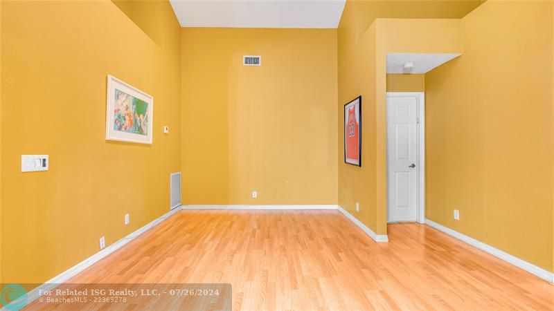 Family room with sliding glass doors leading out to roofed screened patio