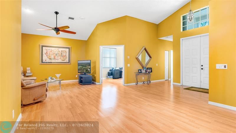 Family room with sliding glass doors leading out to roofed screened patio