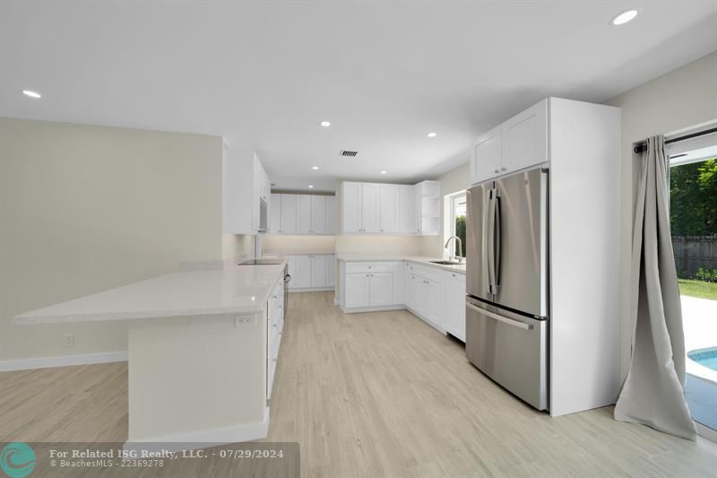 Beautiful, new kitchen with induction stove, smart oven, loads of storage and gorgeous countertops.