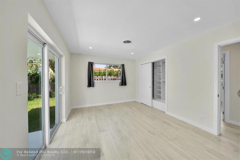 Primary Bedroom with ensuite, built in closet organizers and sliding doors to pool.