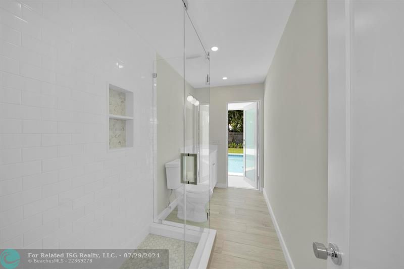 Cabana bath to the pool with custom glass shower.