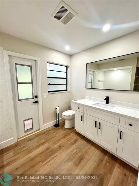 Guest bathroom, vanity and mirror. Cabana bathroom door that leads to the pool.