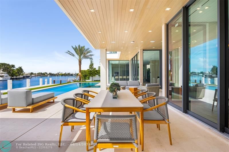 White home centered with backyard facing water. Views of Downtown Fort Lauderdale