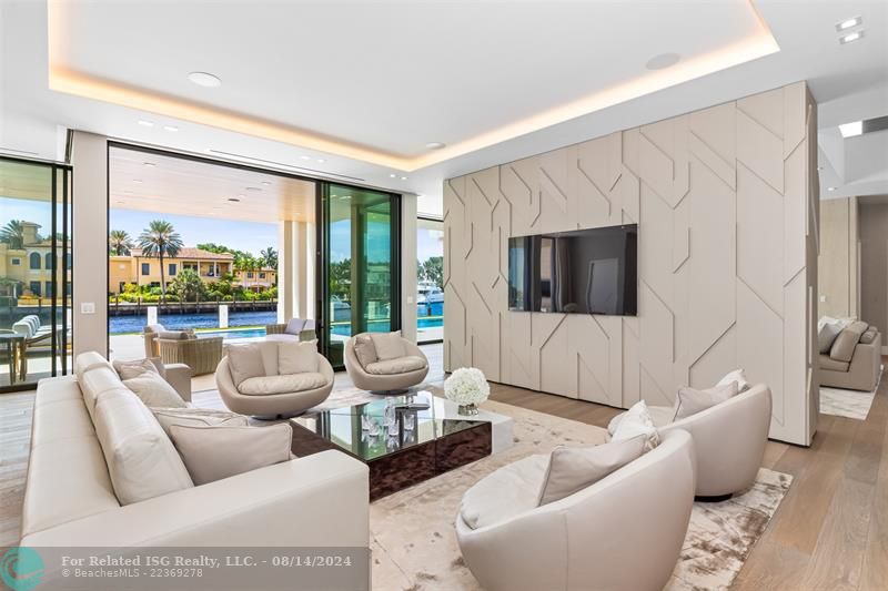 White home centered with backyard facing water. Views of Downtown Fort Lauderdale