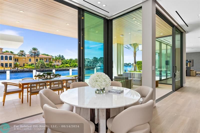 White home centered with backyard facing water. Views of Downtown Fort Lauderdale