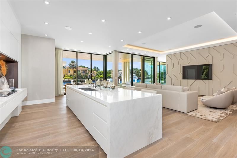 White home centered with backyard facing water. Views of Downtown Fort Lauderdale