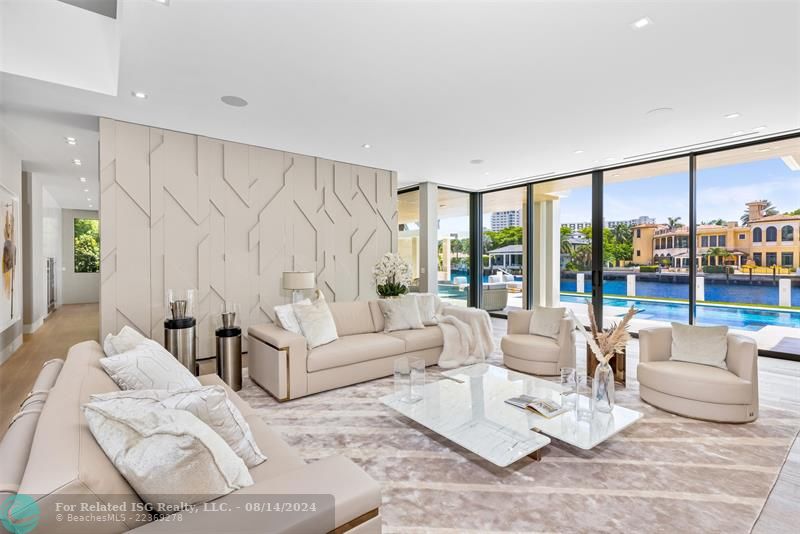 White home centered with backyard facing water. Views of Downtown Fort Lauderdale