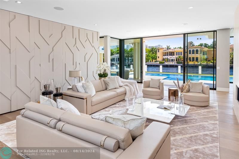 White home centered with backyard facing water. Views of Downtown Fort Lauderdale