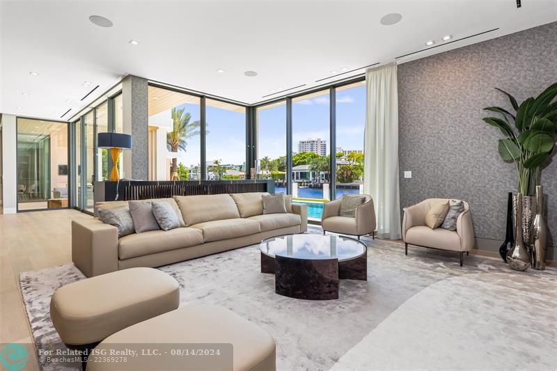 White home centered with backyard facing water. Views of Downtown Fort Lauderdale