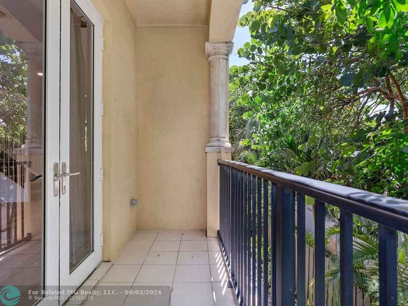 balcony with garden view from living area.