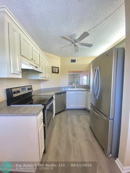 Kitchen with SS Appliances & Newer Luxury Vinyl Flooring!