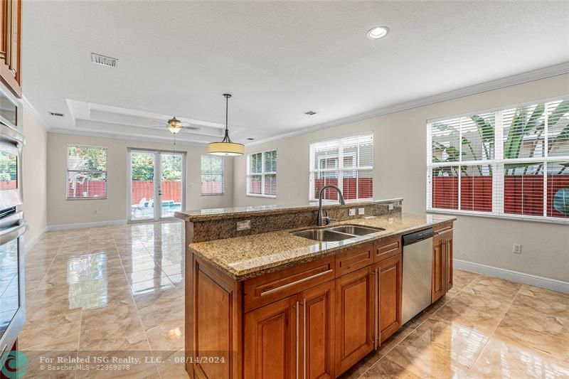 Large kitchen looking toward private pool and backyard.