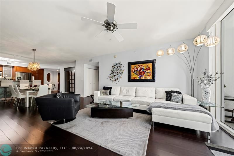 view looking back into the main living area, guest suite in the center, den behind the 'french doors', entry foyer and kitchen