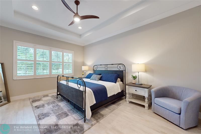 Primary bedroom with trey ceilings