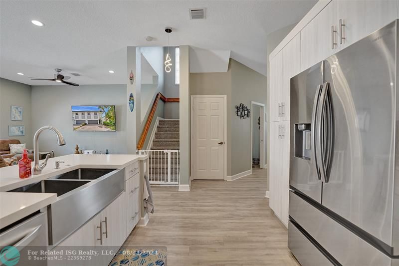 Entry with the garage access on the left and half bath on the right leading to the kitchen and living room.