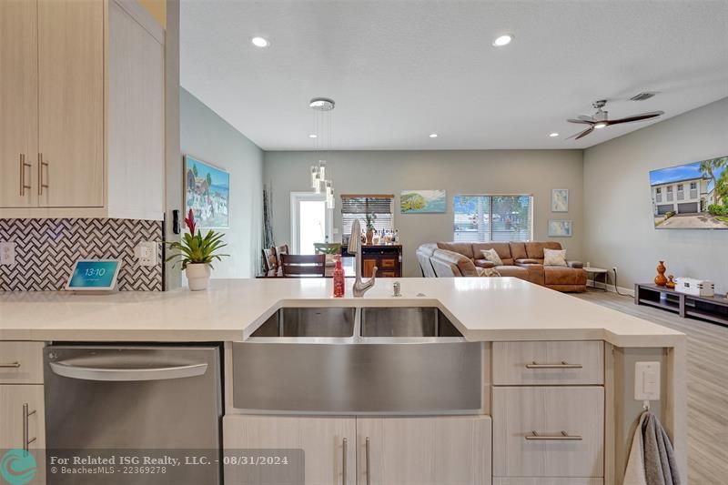 Entry with the garage access on the left and half bath on the right leading to the kitchen and living room.