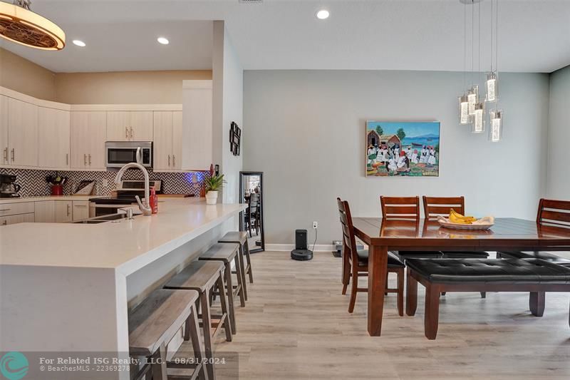 Entry with the garage access on the left and half bath on the right leading to the kitchen and living room.