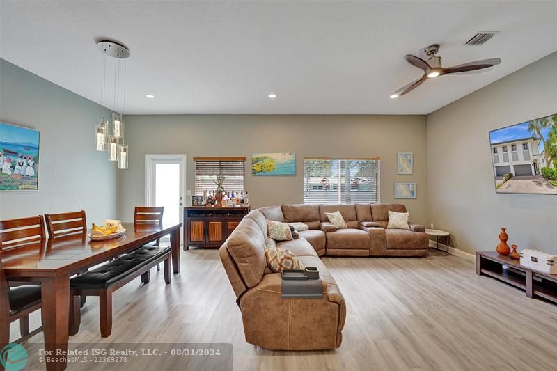 Entry with the garage access on the left and half bath on the right leading to the kitchen and living room.