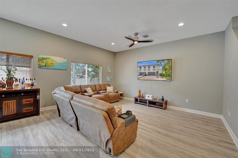 Entry with the garage access on the left and half bath on the right leading to the kitchen and living room.