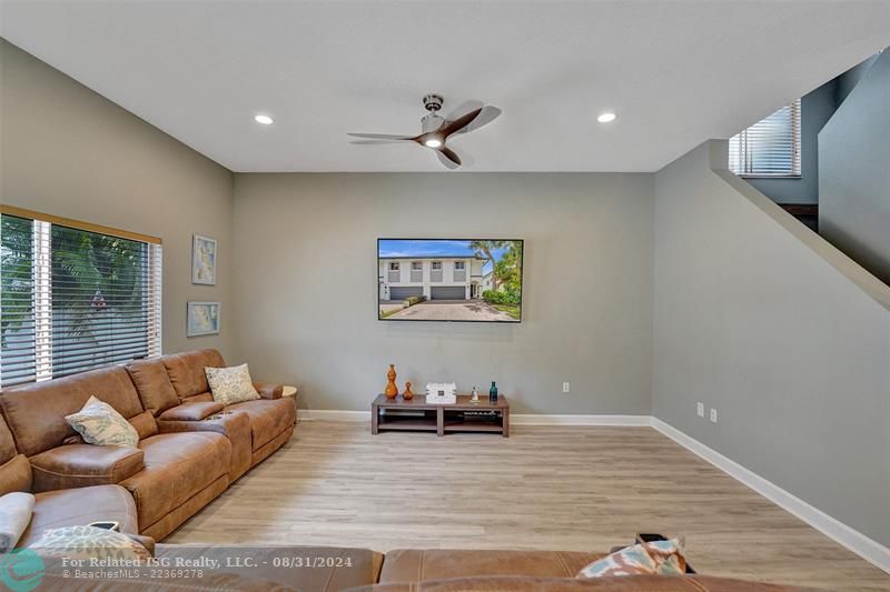 Entry with the garage access on the left and half bath on the right leading to the kitchen and living room.