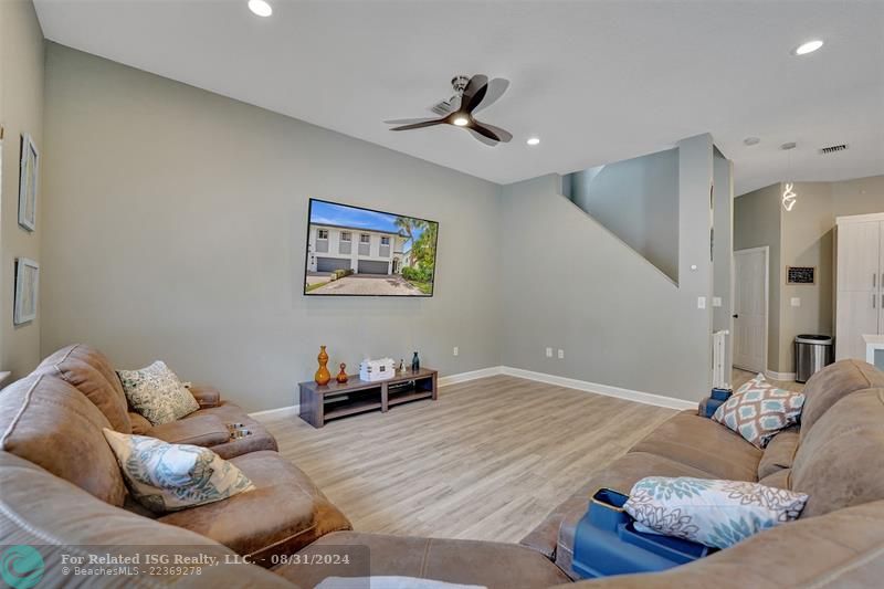 Entry with the garage access on the left and half bath on the right leading to the kitchen and living room.